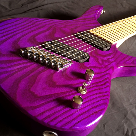 Purple stained seven string multiscale electric guitar